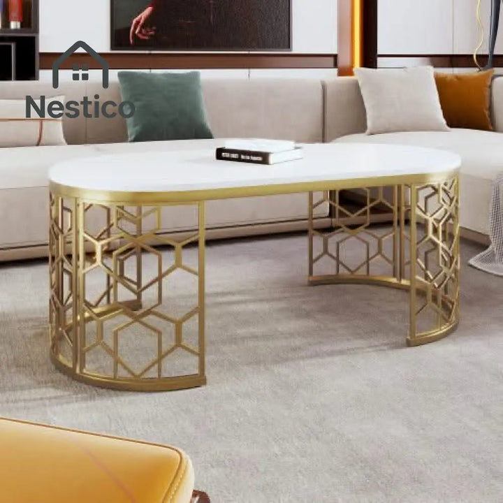 White oval coffee table with gold stainless steel base and cut-out pattern